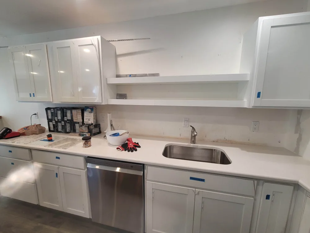 Kitchen during the remodel: cabinets and counters in, sink set