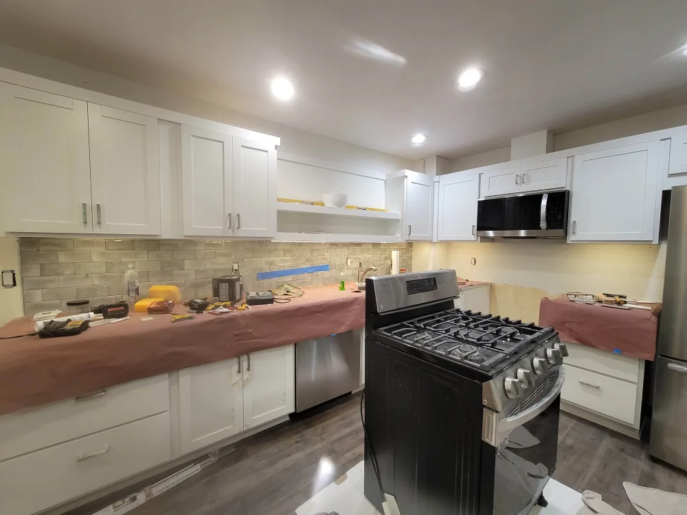 Kitchen with backsplash tiled and range installed