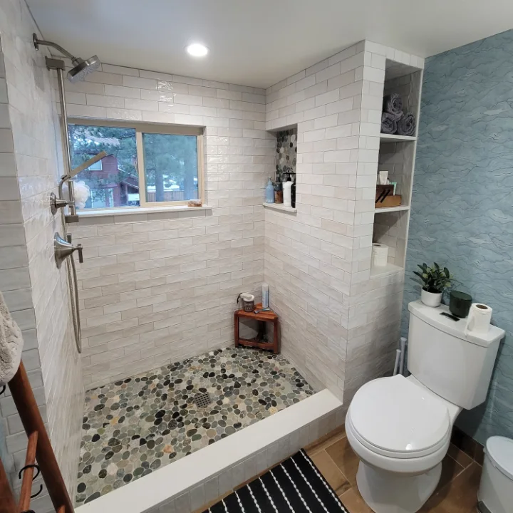 Bathroom with tiled walk-in shower and pebble floor