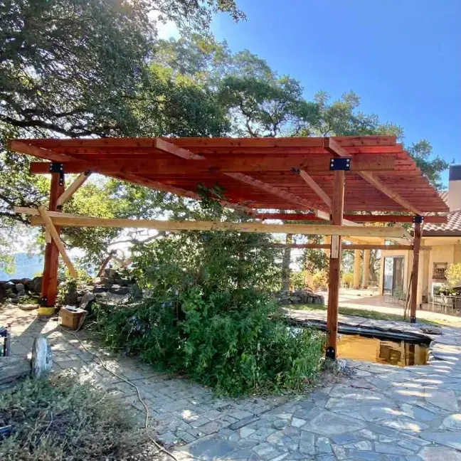 Timber pergola over a stone patio