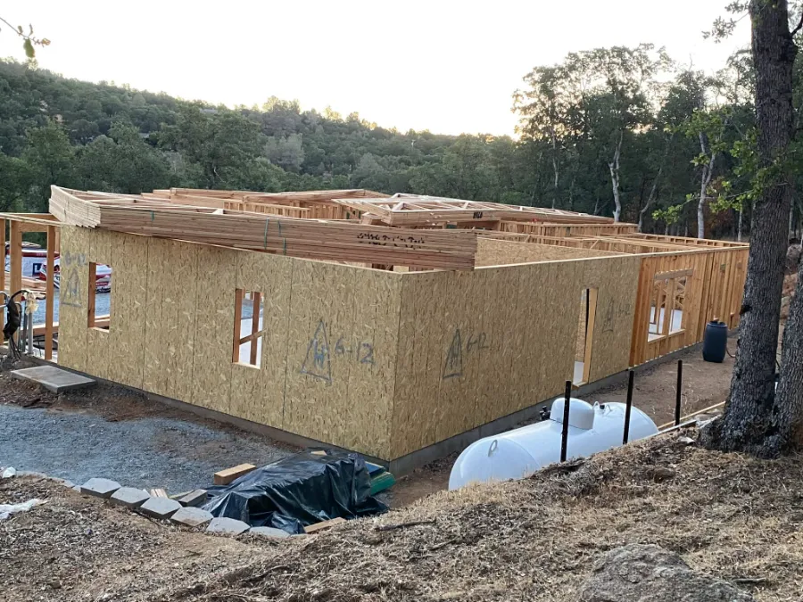 Progress photo: walls sheathed and roof trusses delivered